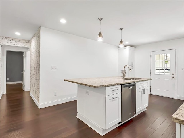 644 Albert St NW, Atlanta, GA 30318 - kitchen with stainless steel dishwasher, dark wood-style floors, white cabinets, light stone counters, and pendant lighting