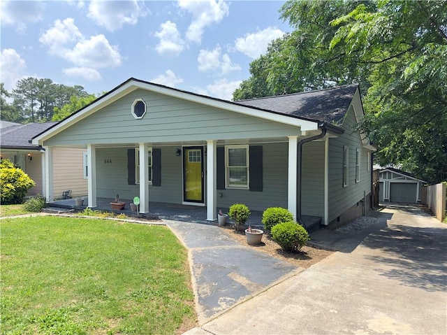 644 Albert St NW, Atlanta, GA 30318 - view of front of property featuring covered porch, a front lawn, and an outbuilding