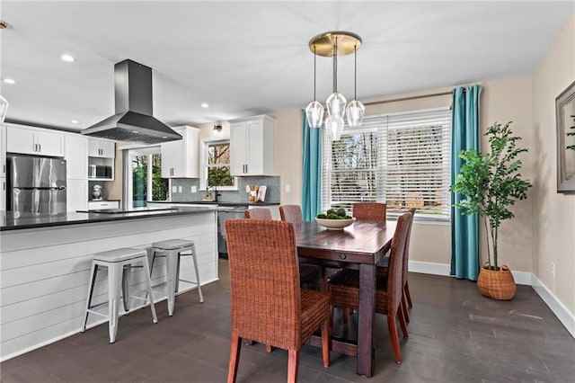 dining space featuring dark wood finished floors, a chandelier, recessed lighting, and baseboards