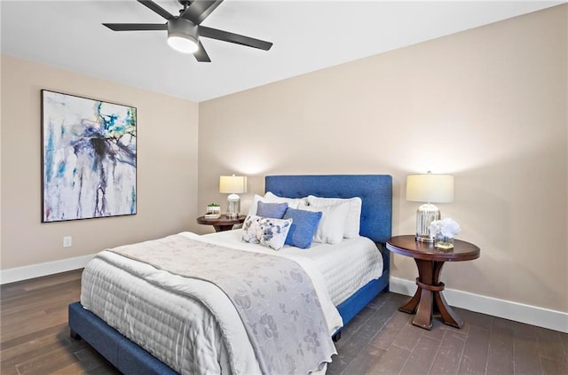 bedroom featuring wood finished floors, baseboards, and ceiling fan