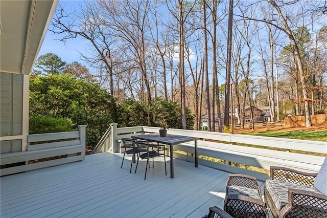 wooden terrace featuring outdoor dining area