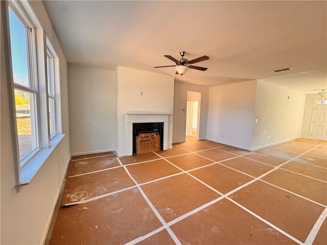 unfurnished living room featuring ceiling fan