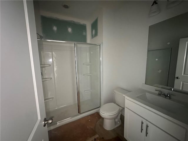 bathroom featuring vanity, toilet, and walk in shower