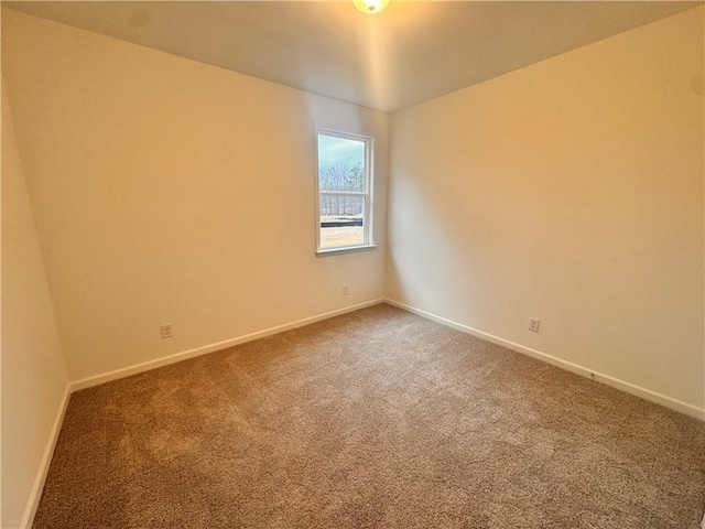 carpeted empty room with baseboards