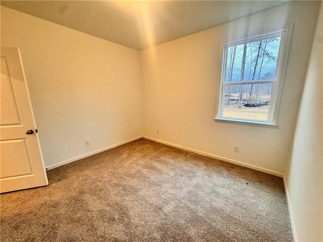 empty room featuring carpet floors and baseboards