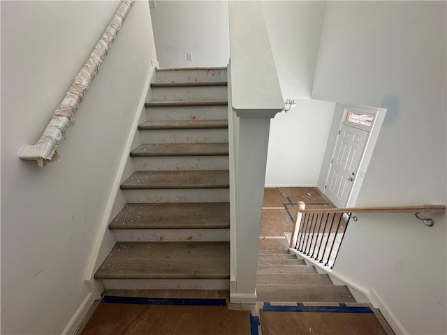 stairway featuring wood-type flooring