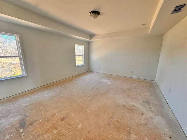 empty room featuring a tray ceiling