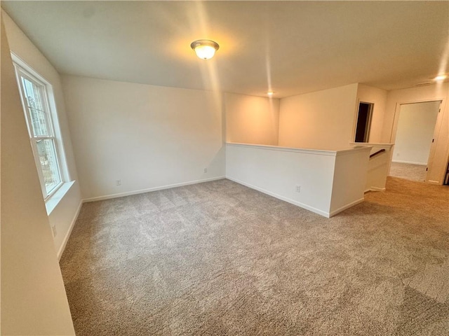 empty room with light carpet and baseboards