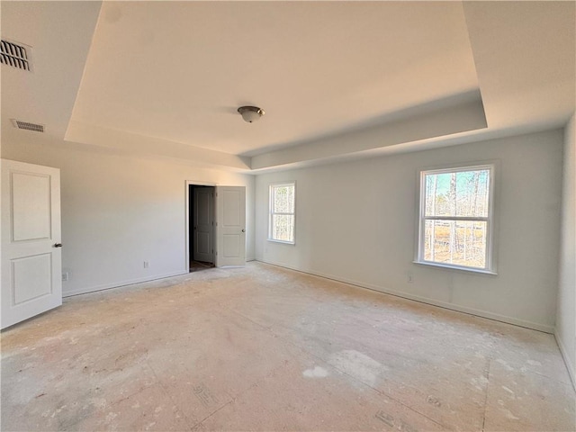 unfurnished bedroom with a tray ceiling