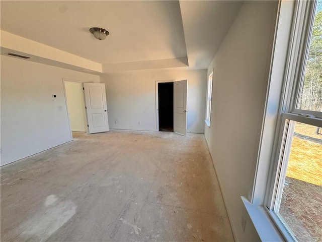 empty room featuring a raised ceiling