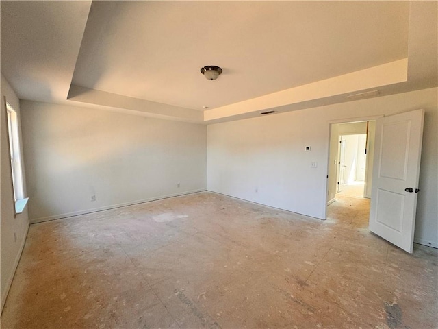 unfurnished room with a tray ceiling