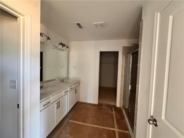 bathroom with concrete flooring, vanity, and walk in shower