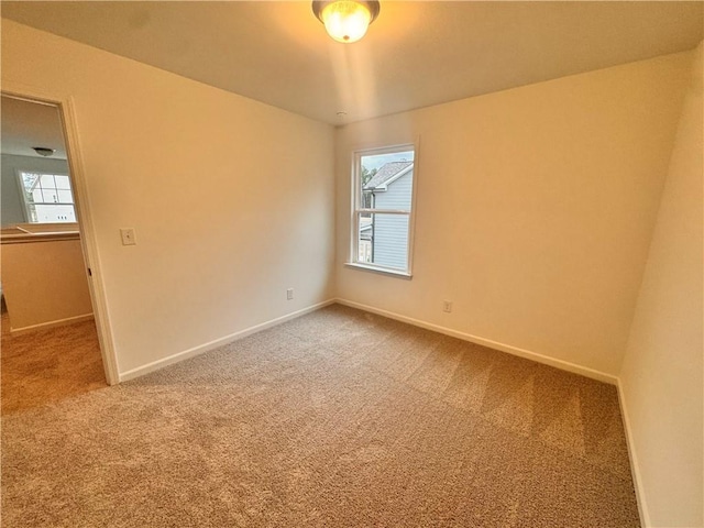 empty room with carpet floors and baseboards