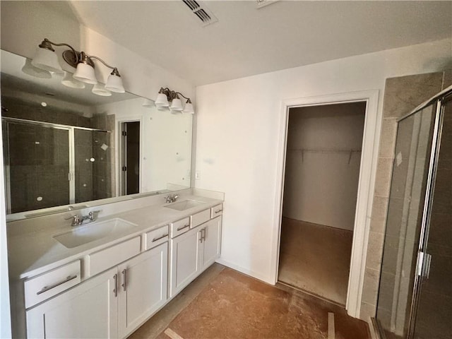 bathroom with vanity, concrete floors, and walk in shower