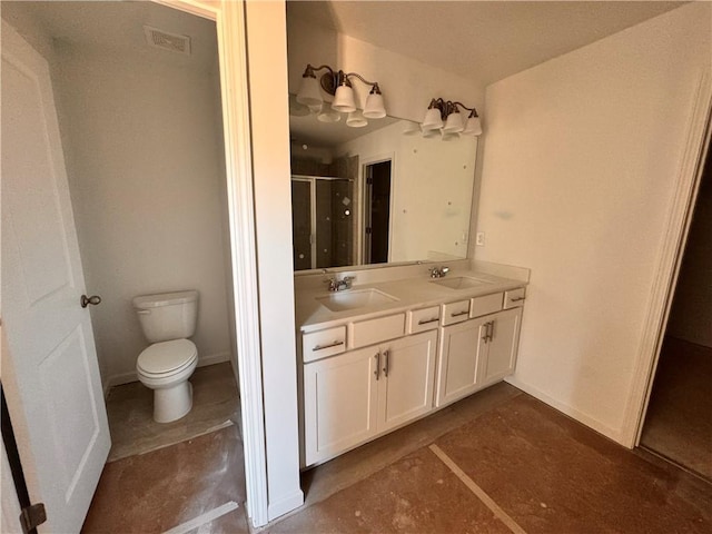 bathroom with vanity, toilet, and a shower with door