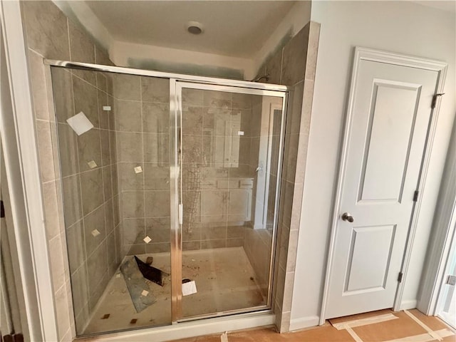 bathroom with tile patterned floors and a shower with shower door