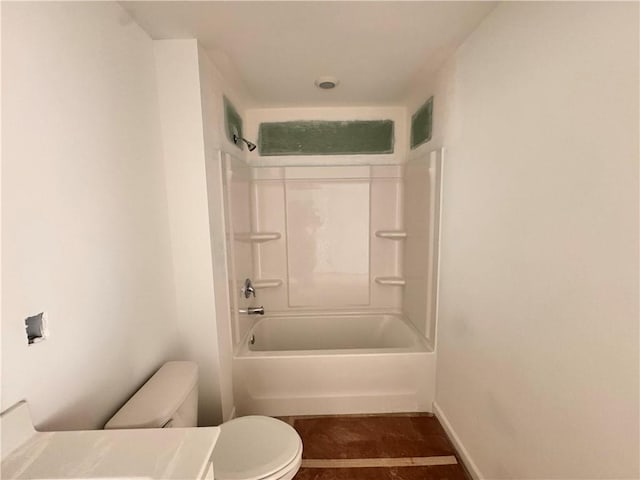 bathroom featuring bathtub / shower combination and toilet