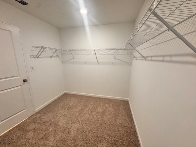 walk in closet featuring carpet floors and visible vents