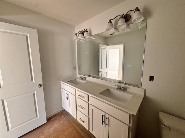 bathroom featuring vanity, toilet, and concrete flooring