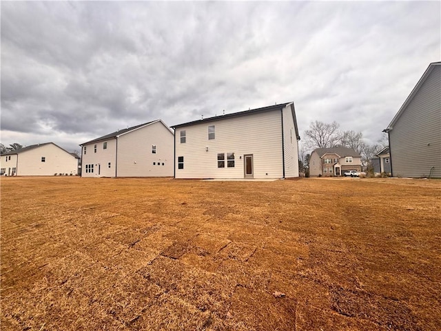 rear view of house with a yard