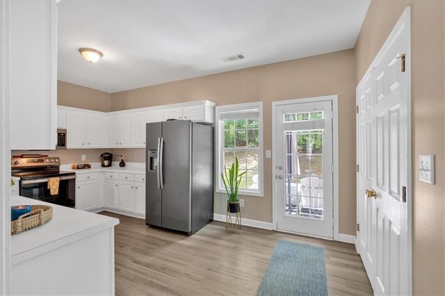 261 Venture Path, Hiram, GA 30141 - kitchen with appliances with stainless steel finishes, light wood-style floors, white cabinets, and light countertops