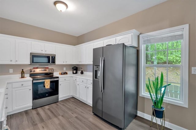 261 Venture Path, Hiram, GA 30141 - kitchen featuring stainless steel appliances, white cabinetry, light wood finished floors, and light countertops