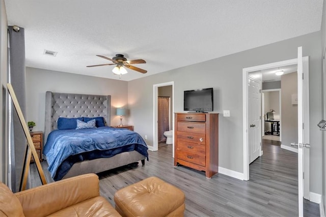 261 Venture Path, Hiram, GA 30141 - bedroom featuring wood finished floors, connected bathroom, and a ceiling fan