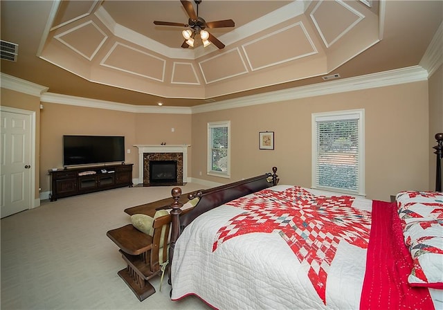 carpeted bedroom featuring visible vents, a fireplace, ornamental molding, and baseboards