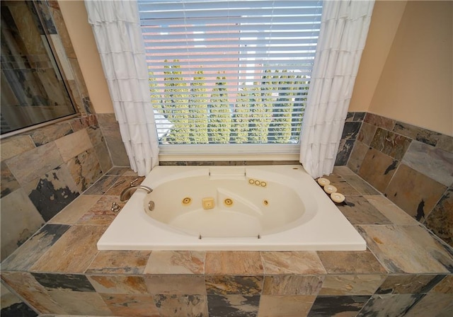 bathroom featuring a jetted tub and a view of city