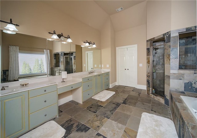 bathroom featuring a stall shower, baseboards, visible vents, a garden tub, and vanity