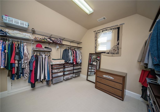 spacious closet featuring lofted ceiling, carpet, and visible vents