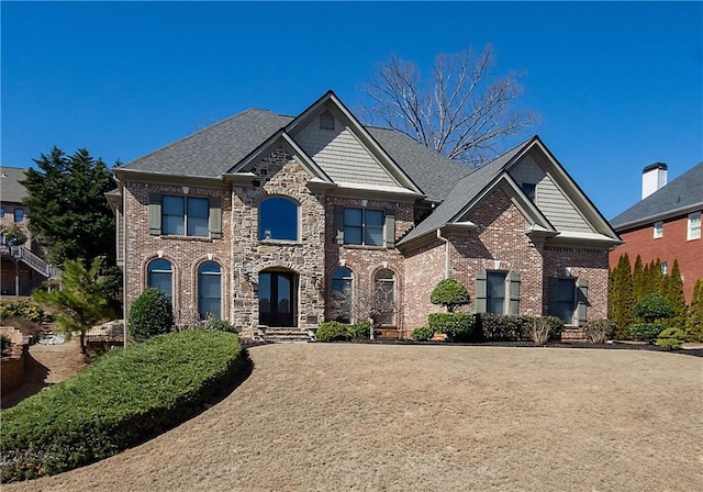 view of front facade with stone siding and brick siding