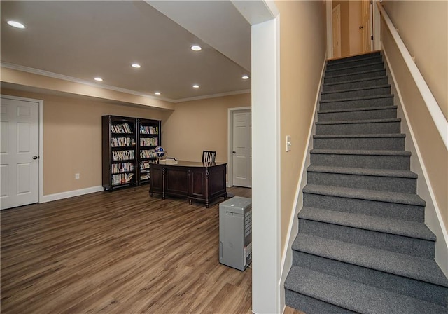 staircase with baseboards, ornamental molding, wood finished floors, and recessed lighting