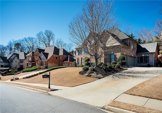 view of front of property featuring driveway, a garage, a residential view, and brick siding