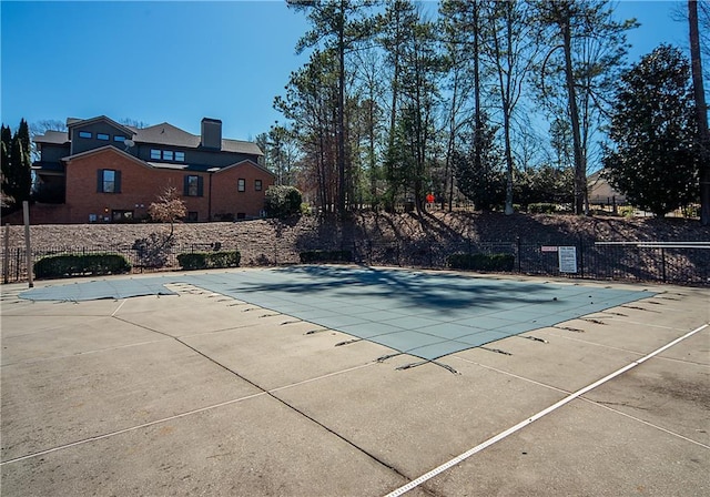 community pool featuring a patio area and fence