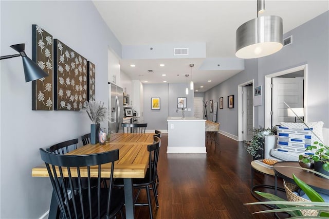 dining area with dark wood-type flooring