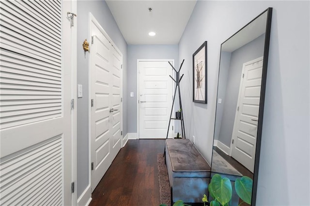 doorway with dark wood-type flooring, recessed lighting, and baseboards