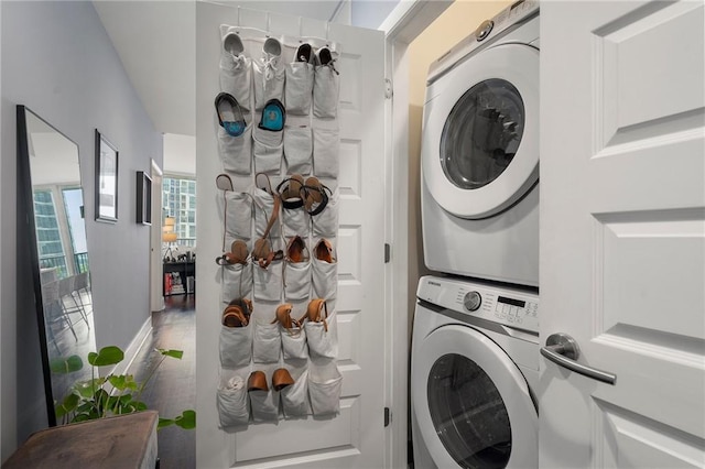 clothes washing area with stacked washer / dryer