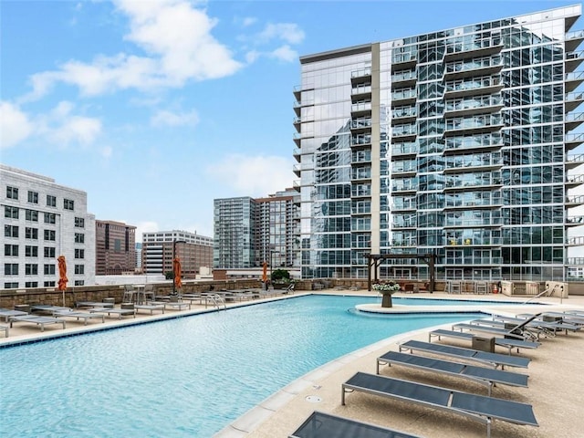 pool with a view of city and a patio area