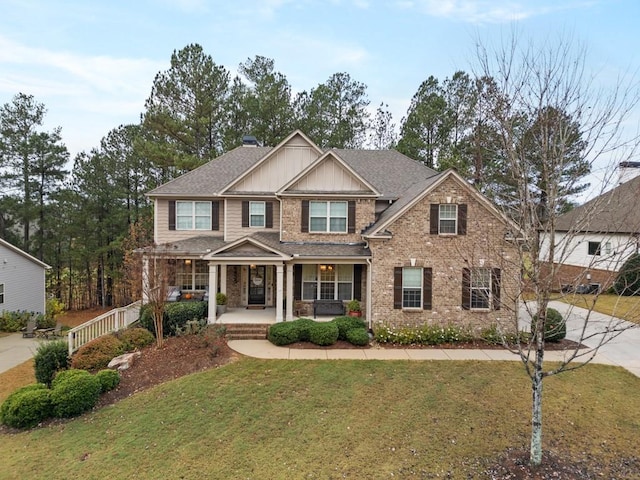 craftsman-style home with a porch and a front yard