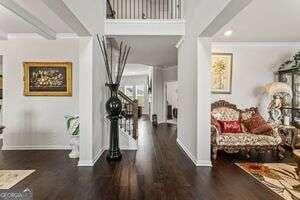 hallway with crown molding and dark wood-type flooring