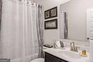 full bathroom with vanity, toilet, and shower / bath combo with shower curtain