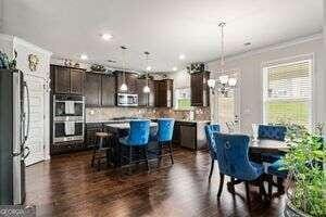 dining area featuring crown molding and dark wood-type flooring