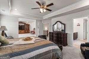 bedroom featuring carpet, ceiling fan, and ornamental molding