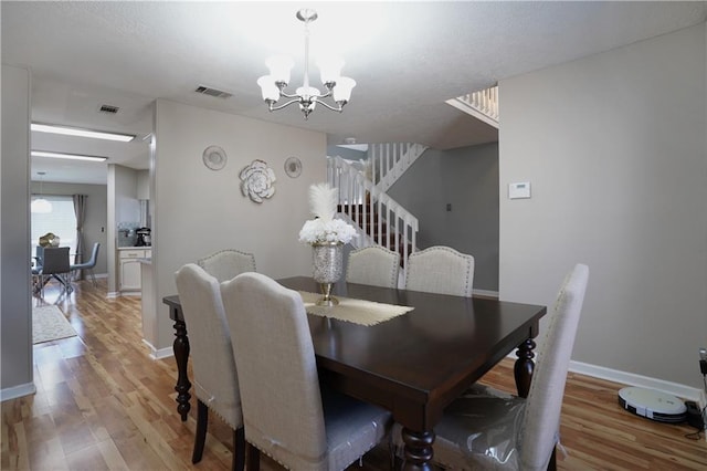 dining room featuring a chandelier and light wood-type flooring