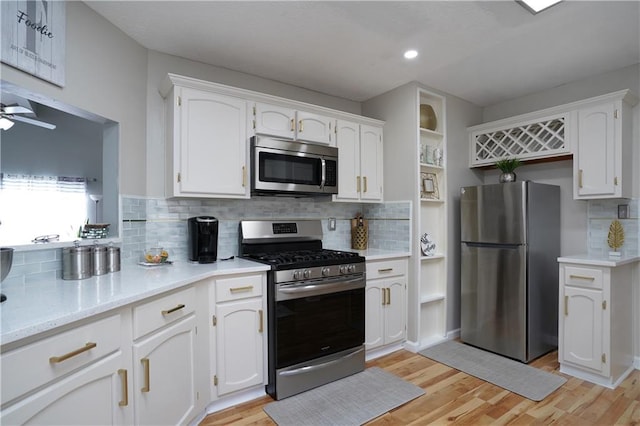 kitchen featuring light hardwood / wood-style floors, white cabinets, and appliances with stainless steel finishes