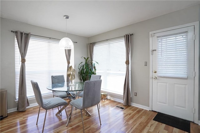 dining space with light hardwood / wood-style floors and a wealth of natural light