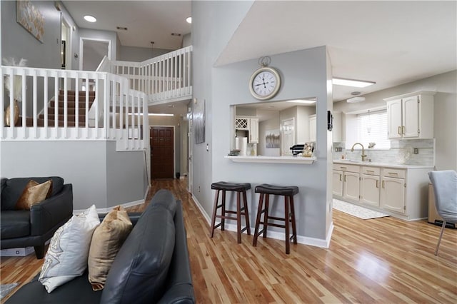 living room with sink and light hardwood / wood-style flooring