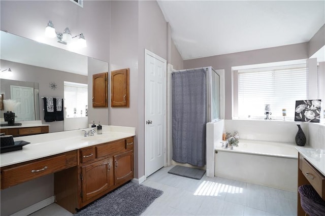 bathroom with vanity, lofted ceiling, and separate shower and tub