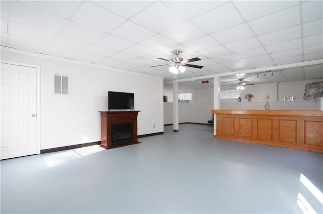 unfurnished living room featuring concrete flooring, a paneled ceiling, and ceiling fan